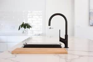 black tap fixture on sink on modern kitchen
