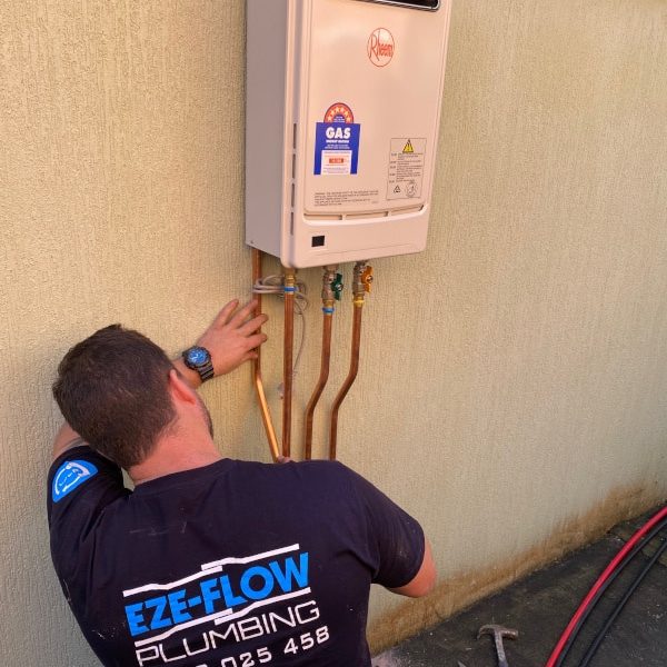 Gas fitter installing gas appliance